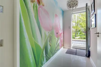 a hallway with a green and pink flower mural at B&B Modern Times in Amsterdam