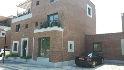 a black car parked in front of a brick building at B&B Modern Times in Amsterdam