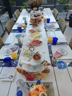 a long table with plates of food on it at B&B Modern Times in Amsterdam