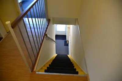 a staircase with yellow and black steps in a building at Bas Apartment Egmond aan Zee in Egmond aan Zee
