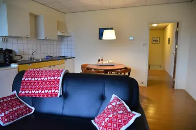 a living room with a couch and a table at Bas Apartment Egmond aan Zee in Egmond aan Zee