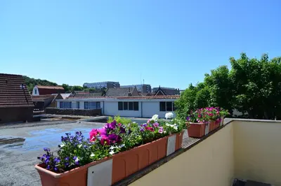 a row of flower boxes on a balcony at Bas Apartment Egmond aan Zee in Egmond aan Zee