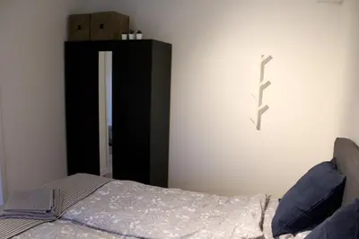 a bedroom with a bed with a cross on the wall at Polderhoek in Woubrugge
