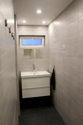 a bathroom with a sink and a window at Polderhoek in Woubrugge