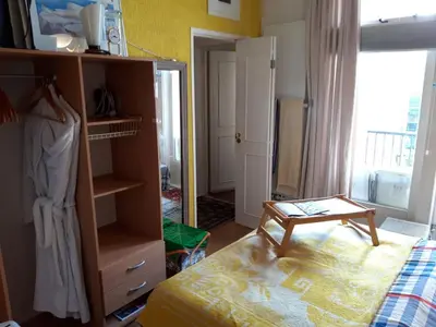 a bedroom with a bed and a dresser and a mirror at Homey Budget Bedroom in Amsterdam