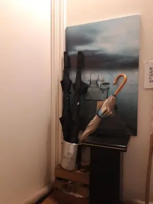 a painting of a woman with an umbrella in a pot at Homey Budget Bedroom in Amsterdam