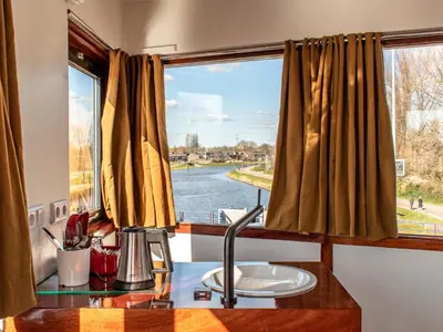 a kitchen with a window with a view of a river at SWEETS - IJdoornlaanbrug in Amsterdam