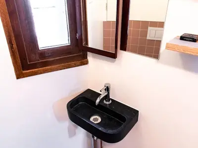 a black sink in a bathroom with a mirror at SWEETS - IJdoornlaanbrug in Amsterdam