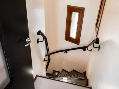 a stairwell with a black rail and a window at SWEETS - IJdoornlaanbrug in Amsterdam