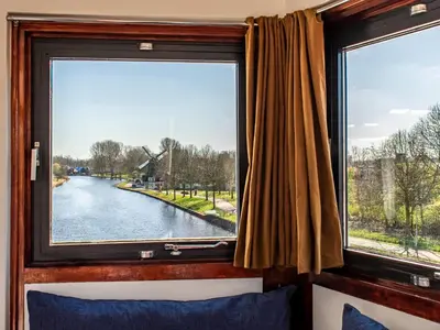 a window in a train with a view of a river at SWEETS - IJdoornlaanbrug in Amsterdam