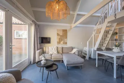 a living room with a couch and a table at De Grote Stern in Groet