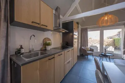 a kitchen with a sink and a counter top at De Grote Stern in Groet