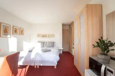 a bedroom with a large white bed in a room at Studio 19 with private parking in Zandvoort