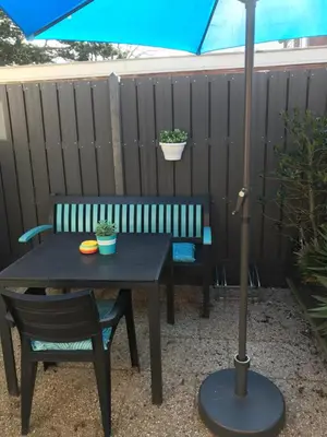 a table and chairs and an umbrella on a patio at Mikasabeach in Zandvoort