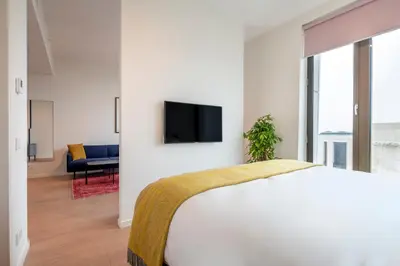 a bedroom with a bed and a tv on a wall at PREMIER SUITES Amsterdam in Amsterdam
