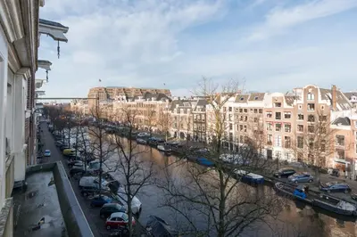 a view of a city with a river and buildings at Empire suites roof terras in Amsterdam