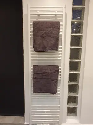 two towels are hanging in a white closet at Studio Adanni in Zandvoort