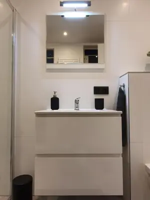 a bathroom with a sink and a mirror at Studio Adanni in Zandvoort