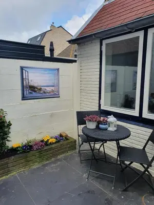 a patio with a table and chairs on a house at Studio Adanni in Zandvoort