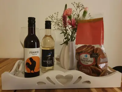 a tray with two bottles of wine and bread at Studio Adanni in Zandvoort