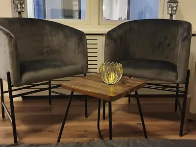 two chairs and a coffee table with a glass bowl on it at Studio Adanni in Zandvoort