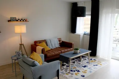a living room with a couch and a table at Landzicht in Woubrugge
