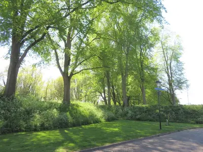 a path in a park with trees and grass at Holiday apartment with free parking Boven Jan Enkhuizen in Enkhuizen