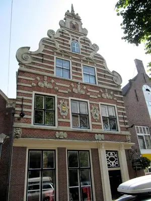 a tall brick building with a clock tower on top at Holiday apartment with free parking Boven Jan Enkhuizen in Enkhuizen