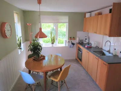 a kitchen with a table and chairs and a sink at Holiday apartment with free parking Boven Jan Enkhuizen in Enkhuizen