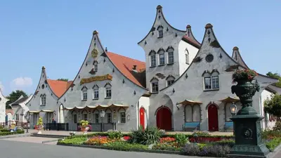 a large white building with a red roof at Holiday apartment with free parking Boven Jan Enkhuizen in Enkhuizen