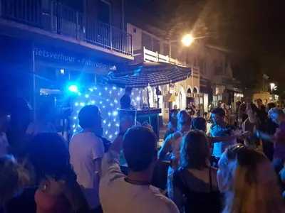 a crowd of people on a street at night at Sunset Lodge in Zandvoort