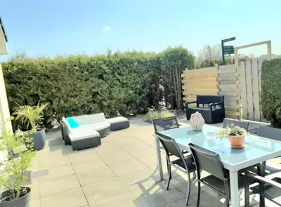 a patio with a blue table and chairs at Huisje Finn, met grote tuin en veel privacy in Dirkshorn
