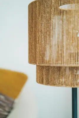 a close up of a lampshade next to a table at Tiny Beach House Zandvoort in Zandvoort