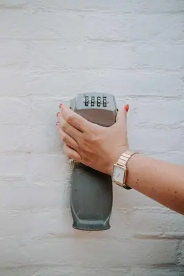 a person holding a remote control in a wall at Tiny Beach House Zandvoort in Zandvoort