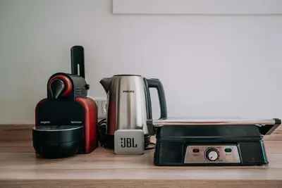 a kitchen counter with a coffee maker and a toaster at Tiny Beach House Zandvoort in Zandvoort
