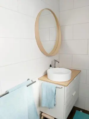 a bathroom with a sink and a mirror at Luxury Suites Oosterwold in Almere