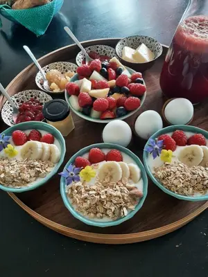 a tray of food with bowls of fruit and nuts at Luxury Suites Oosterwold in Almere