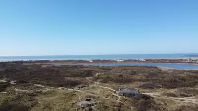 an aerial view of the ocean and a house at Duindoorn 45 in IJmuiden