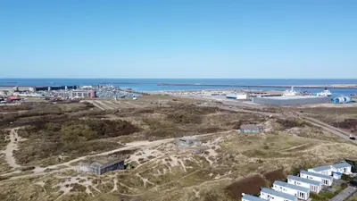 an aerial view of a beach with buildings and the ocean at Duindoorn 46 in IJmuiden