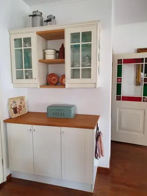 a kitchen with white cabinets and a counter at Bed & breakfast FF rust in Kockengen