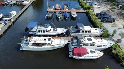 a group of boats are docked in a harbor at Motor Yacht Almaz in Amsterdam