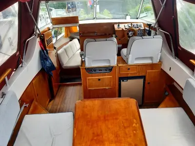 an interior of a boat with a table and chairs at Motor Yacht Almaz in Amsterdam
