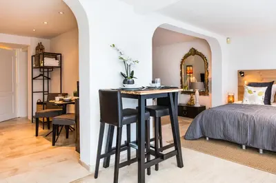 a bedroom with a bed and a desk and a table at Souterrain Zuid-Duinen -Free Parking in Zandvoort