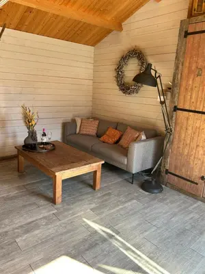 a living room with a couch and a coffee table at Chalet peter in Limmen