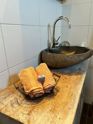 a bathroom counter with a sink and two towels at Chalet peter in Limmen