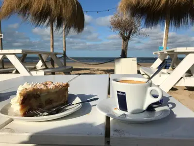 a table with a piece of cake and a cup of coffee at Chalet peter in Limmen