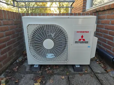 an air conditioner is sitting outside of a building at House close to beach and city in Hoorn