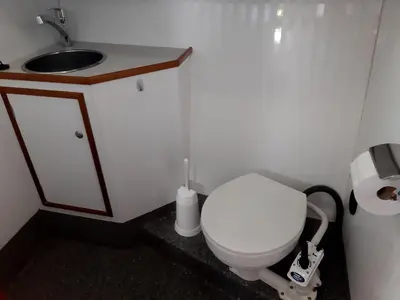 a small bathroom with a toilet and a sink at Motor Yacht Amazone in Amsterdam