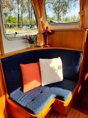 a bench in the back of a train with two pillows at Motor Yacht Amazone in Amsterdam
