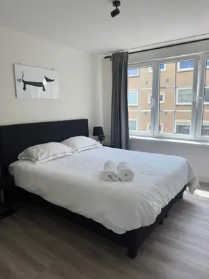 a bedroom with a bed with two towels on it at Beach Studio in Zandvoort
